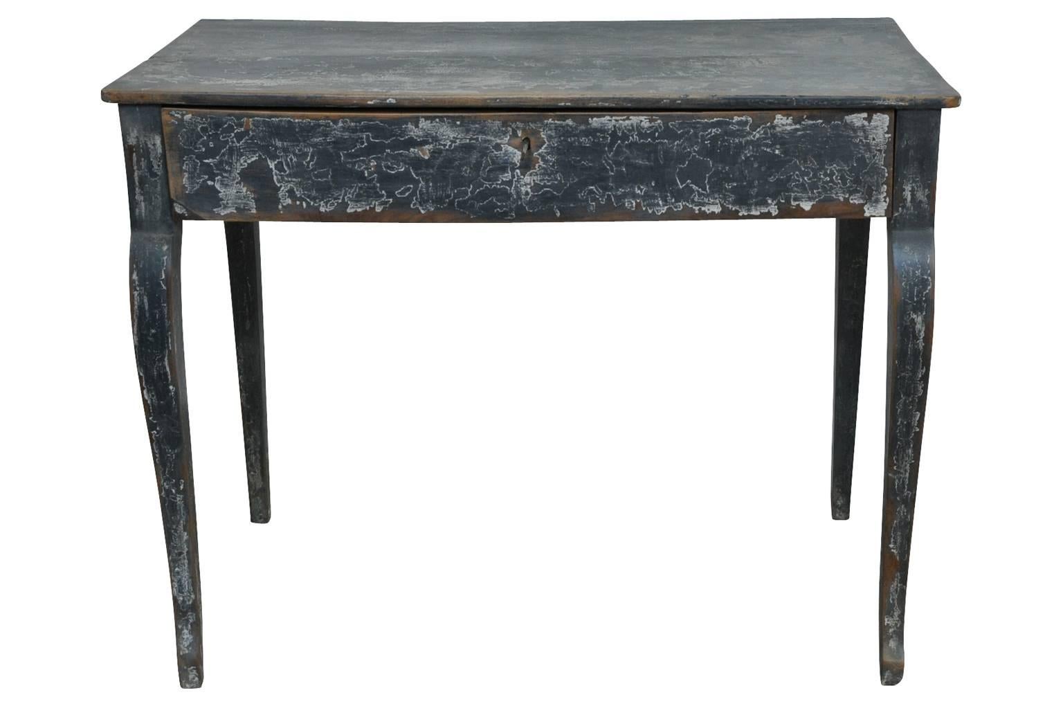 A very charming later 19th century small desk or side table in painted wood. Wonderful painted finish a great patina. One drawer over gentle cabriole legs. A perfect bedside table as well.