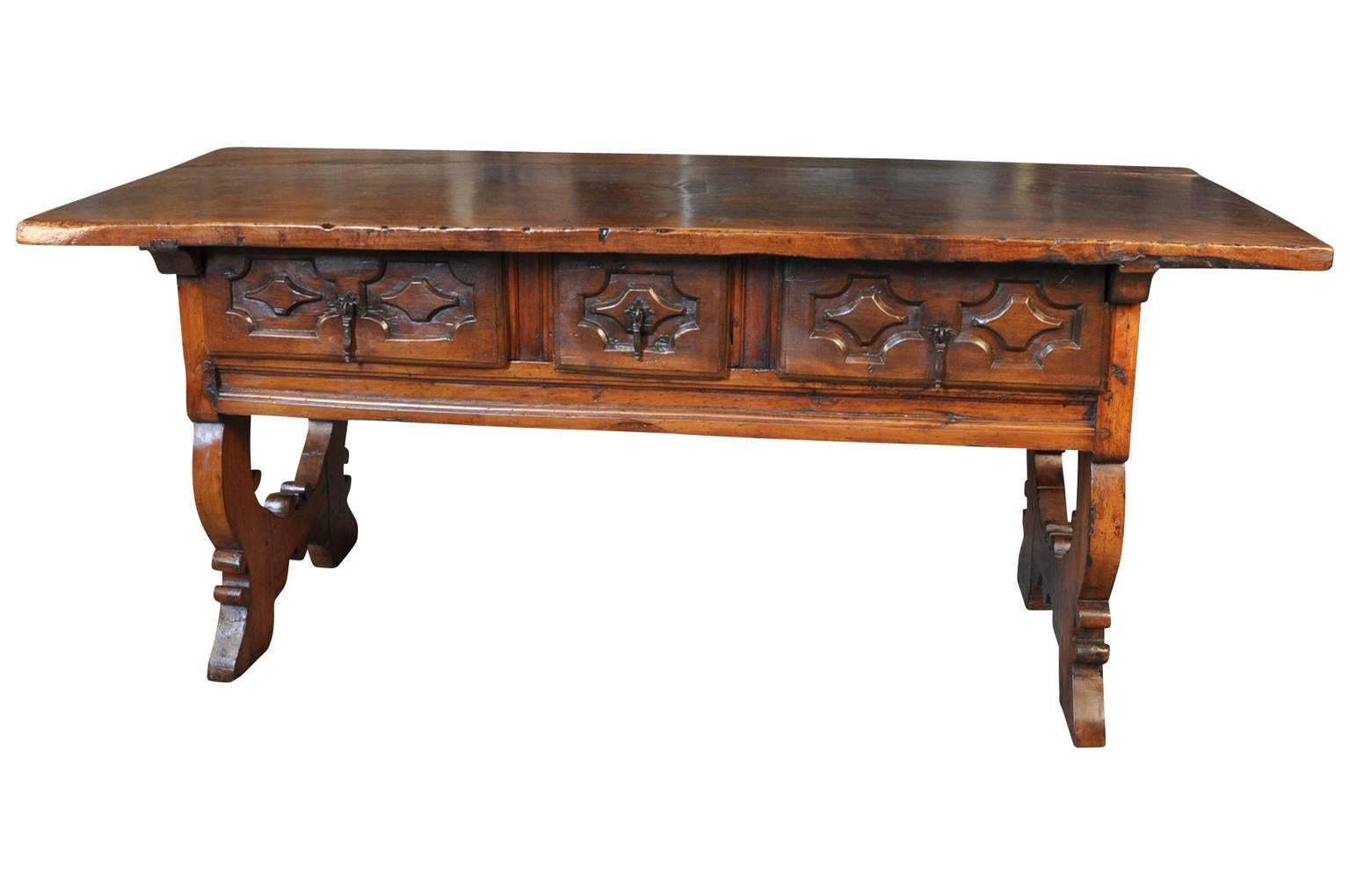 A very handsome 18th century table or desk from the Catalan region of Spain. Beautifully constructed from walnut with three drawers and wonderfully shaped legs. Perfect as a console or sofa table as well.