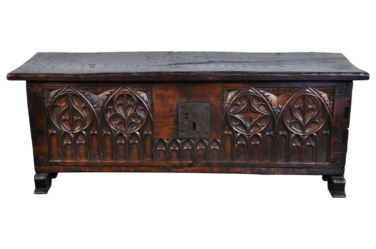 A very handsome 18th century Gothic style trunk from the Catalan region of Spain. Beautifully constructed from chestnut with a solid board top and wonderful carving detail. Terrific at the base of a bed or as a coffee table. Great patina - very rich
