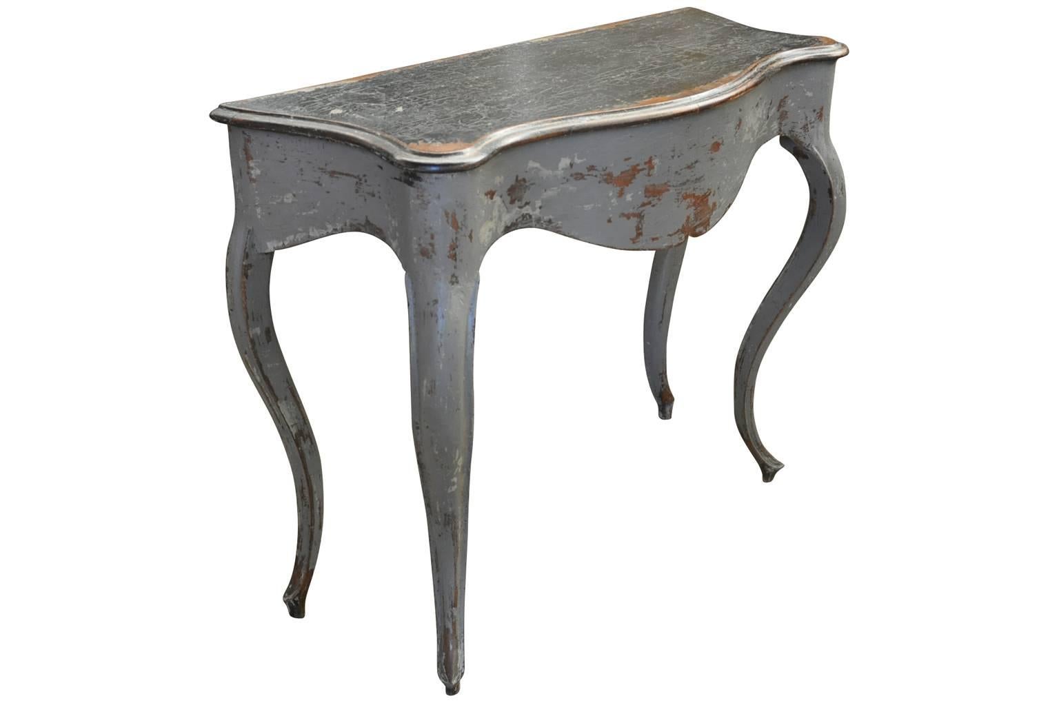 A very charming later 19th century Louis XV style console table in painted wood. Terrific painted finish.