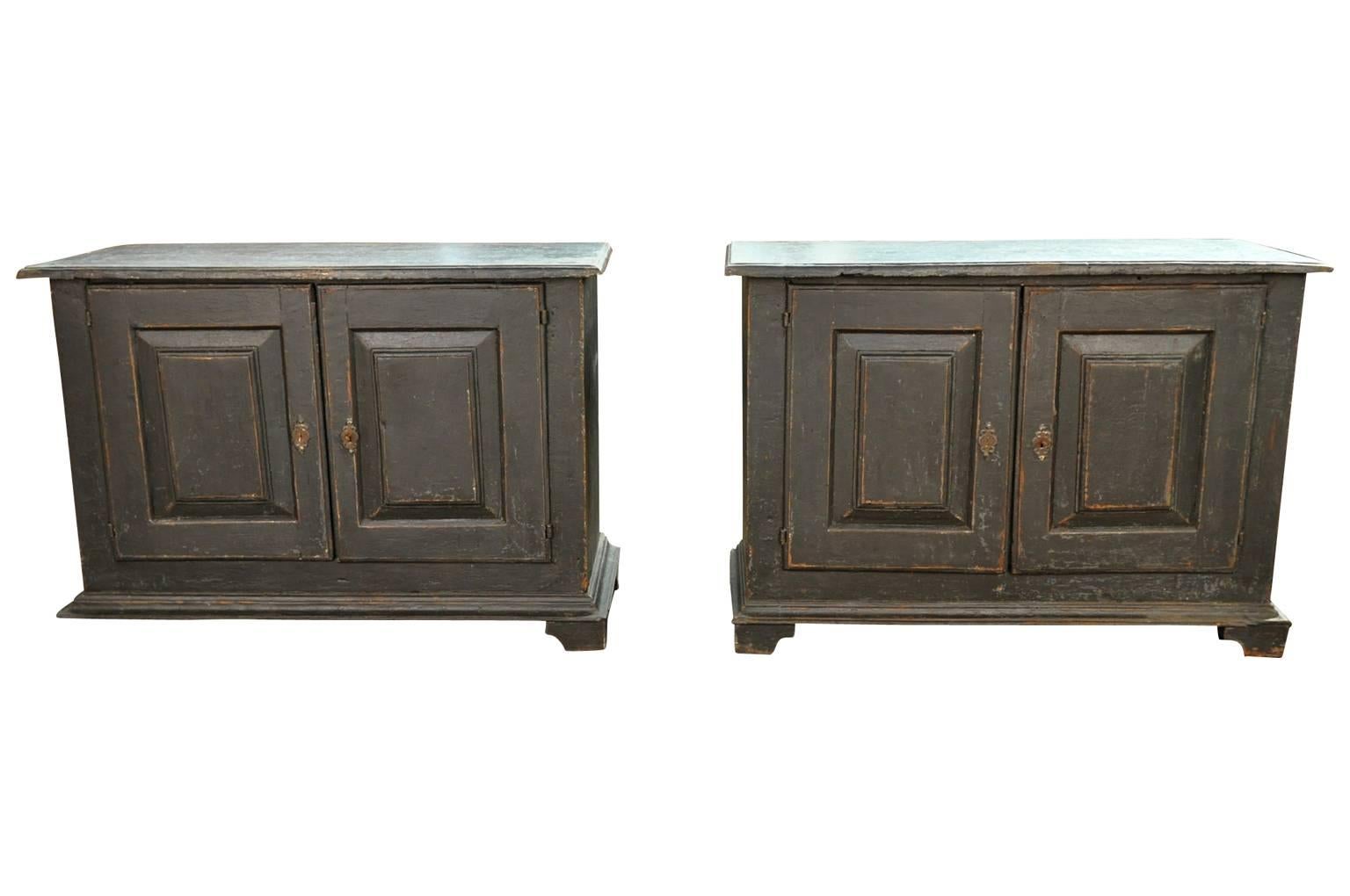 A very handsome pair of 18th century buffets from Spain. Very soundly constructed from painted wood with boldly molded door panels raised on plinth feet. Perfect cabinets to flank a fireplace. These buffets may be sold as a pair of individually. The