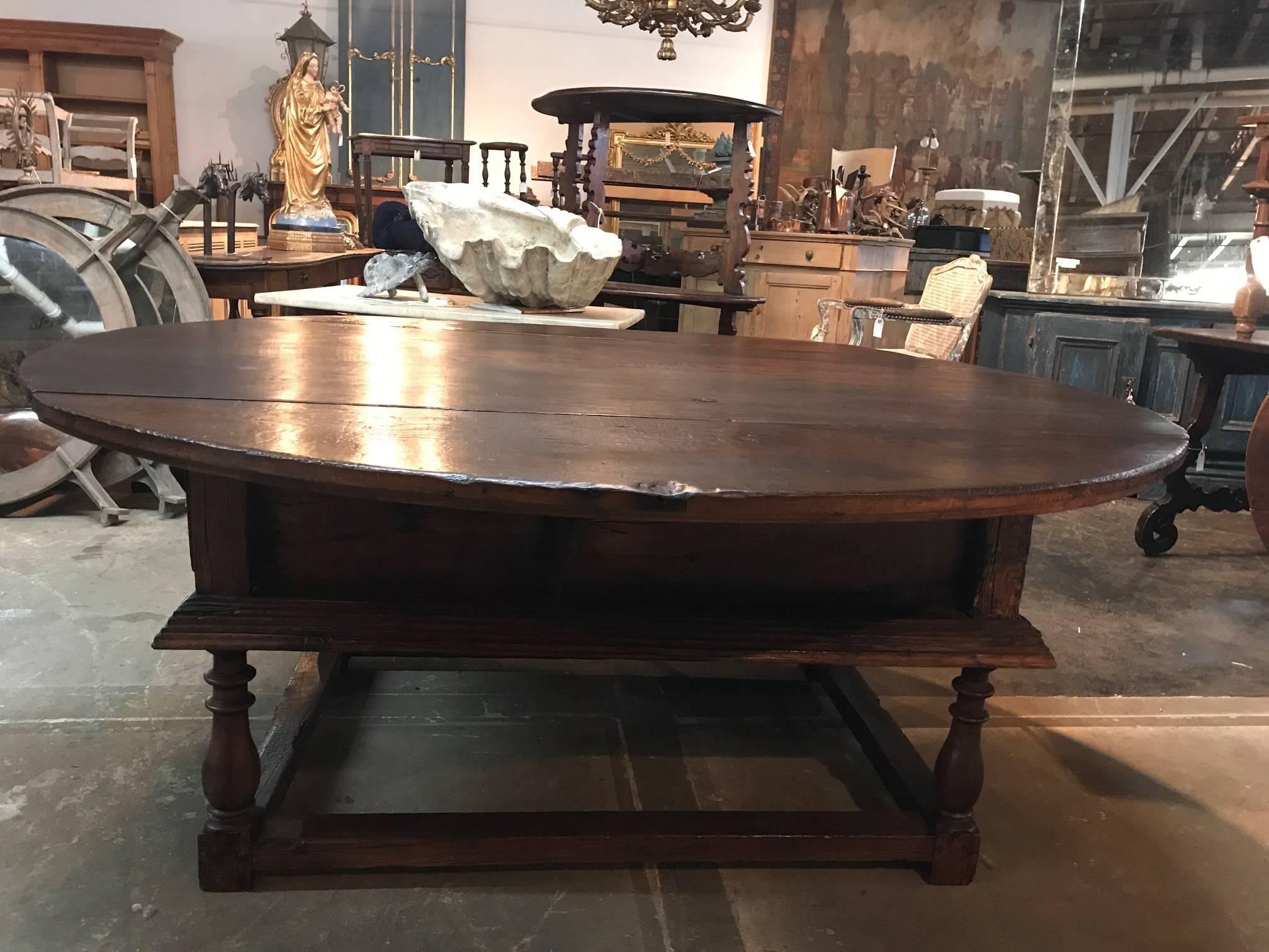 Outstanding and very rare early 18th century round table from Northern Italy. Exceptional construction in very sound chestnut with two large drop leaves and two drawers. The leaves have retracting iron supports to maintain the leaves in place once