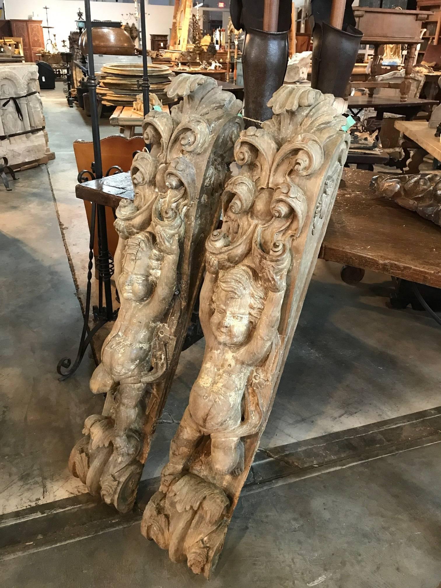 An exquisite and outstanding pair of early 17th century architectural elements magnificently carved from walnut. These corbels are decorated with a delightful pair of Putti with endearing faces. Wonderful to incorporate into any construction.