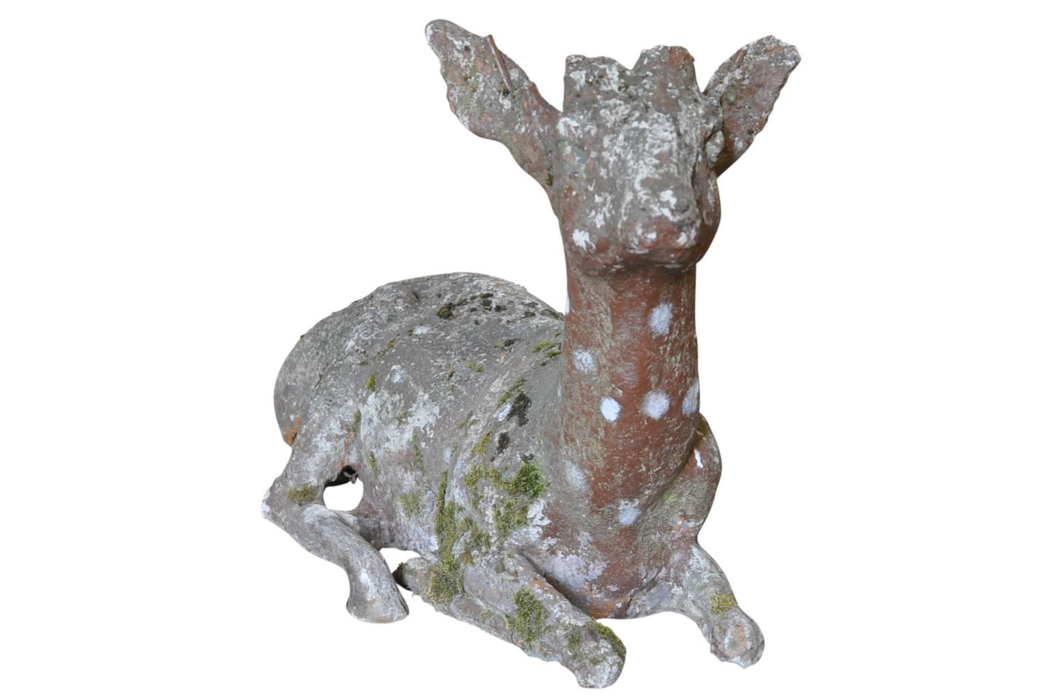 An absolutely charming French 19th century statue of a recumbent deer beautifully crafted in coade stone. Wonderful detail and beautiful face. A perfect accent for any garden or interior.