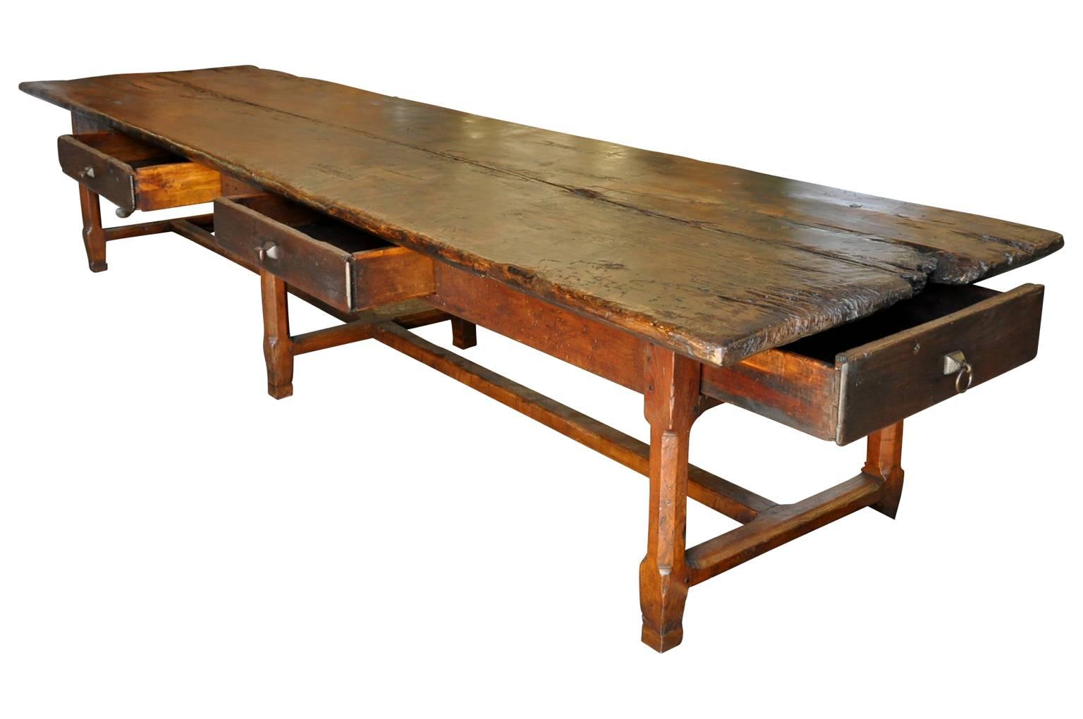 A monumental farm table from the South of France. Handsomely constructed from beautifully patina'd oak and chestnut with four drawers. A tremendous piece for very large family gatherings, a sensational island - or an exceptional store display piece.