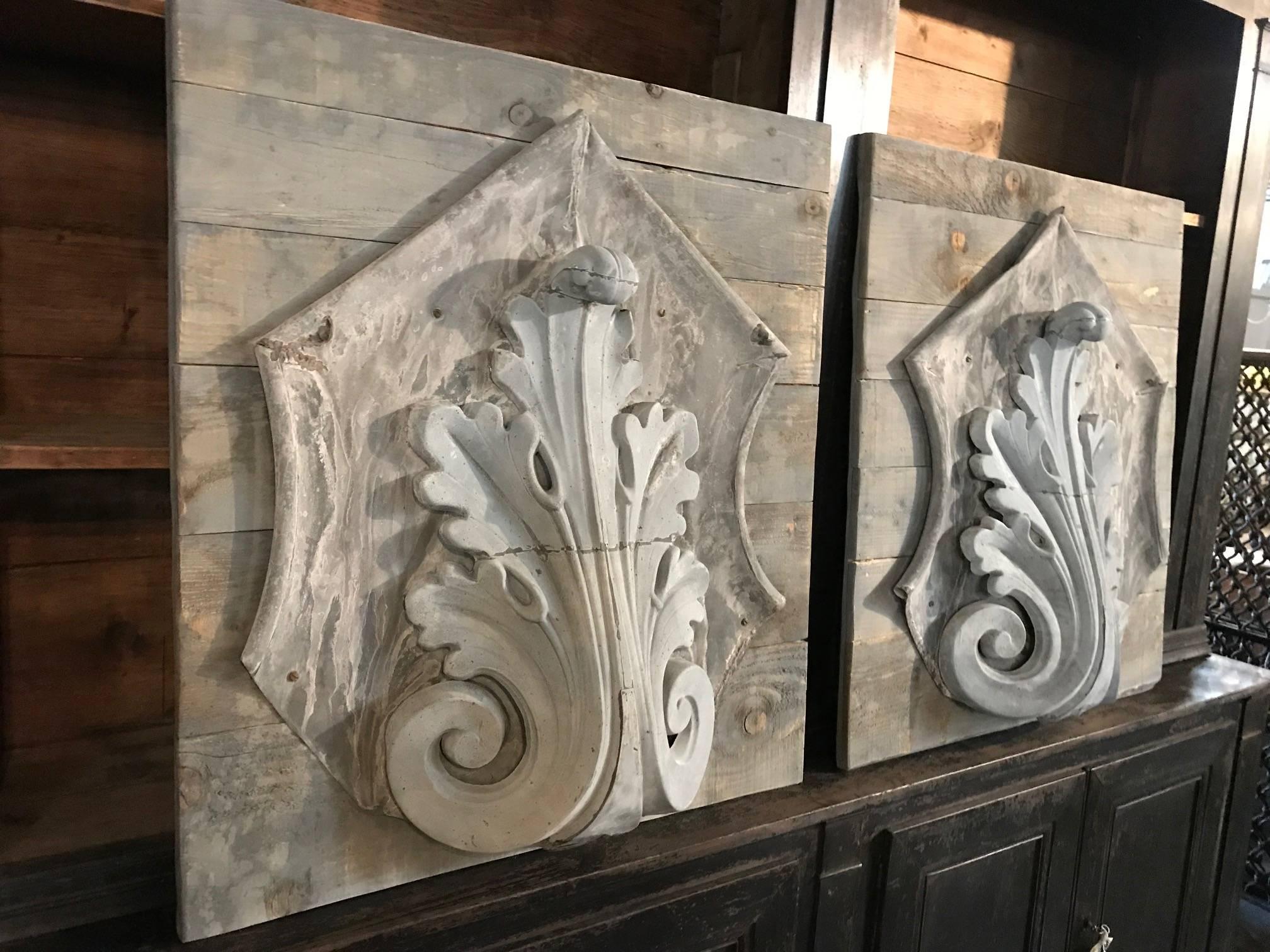 A delightful pair of 19th century zinc architectural fragments from a building in Paris - now mounted on wooden panels. Terrific architectural artwork for any interior or exterior.