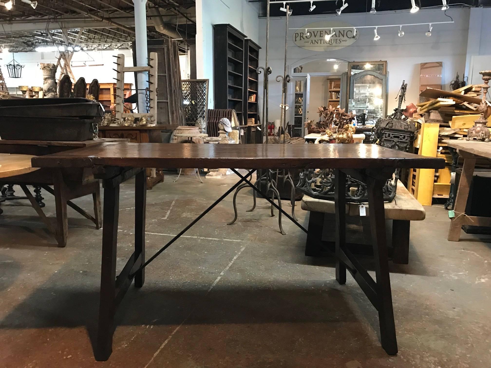 An exceptional late 17th century writing table from the Catalan region of Spain. Wonderfully constructed from walnut with hand forged iron stretchers and iron bindings. The patina is outstanding very rich and luminous. The table's minimalist design