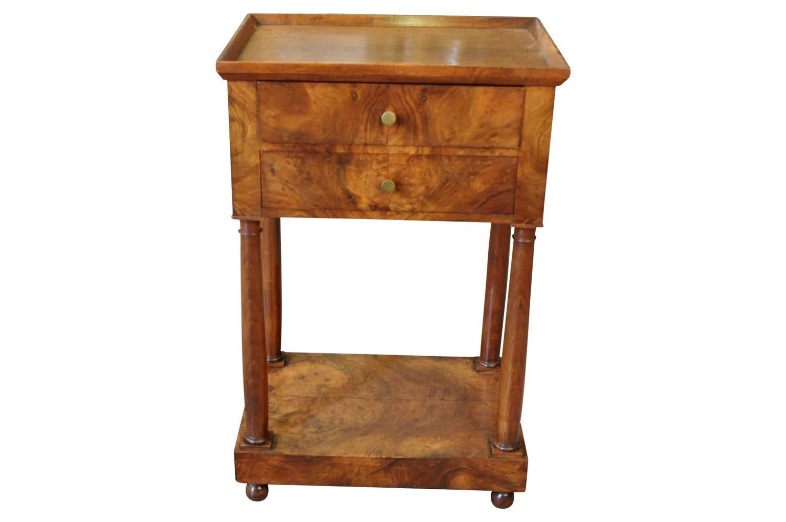 A very charming French early 19th century side table beautifully constructed from walnut with two drawers, handsomely turned legs and base platform. Wonderful patina.