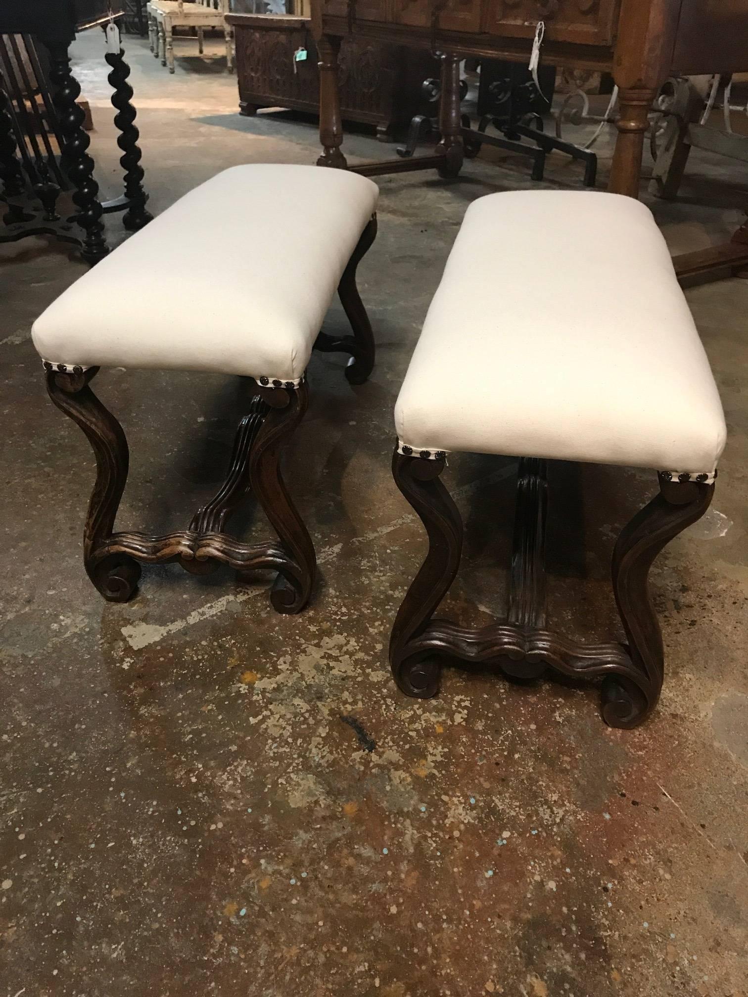 A very charming pair of later 19th century French Louis XIII style benches - banquettes. Beautifully constructed from walnut and recently reupholstered.