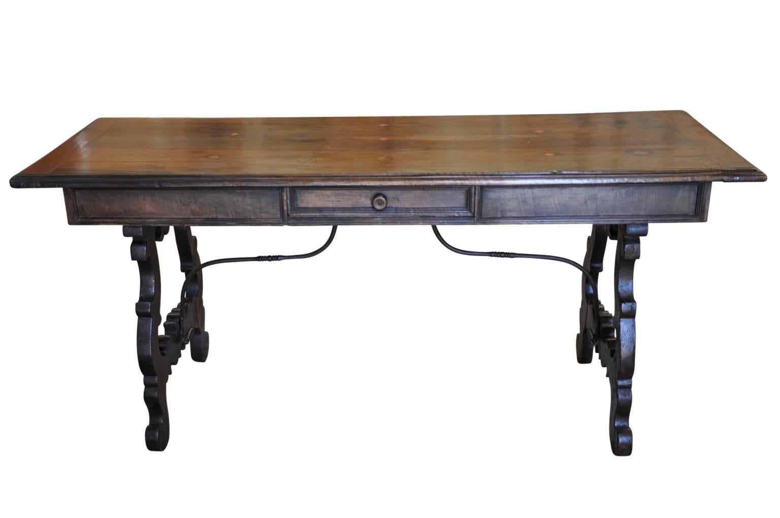 A very stately early 19th century desk from Northern Italy. Handsomely constructed from walnut with one drawer, classical lyre shaped legs and hand forged iron stretchers. A very beautiful desk that will serve nicely as a sofa table as well. Great