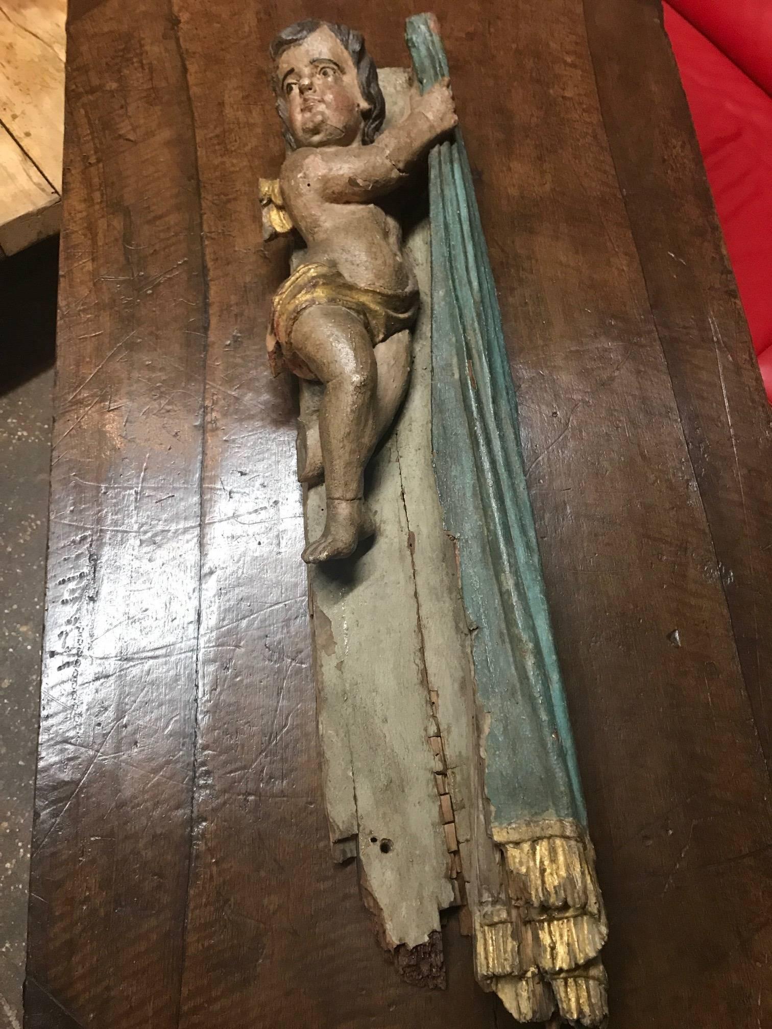 A stunning architectural element of a 17th century Putto - Angel from the Veneto region of, Italy. Beautifully carved from wood with an outstanding polychromed finish.