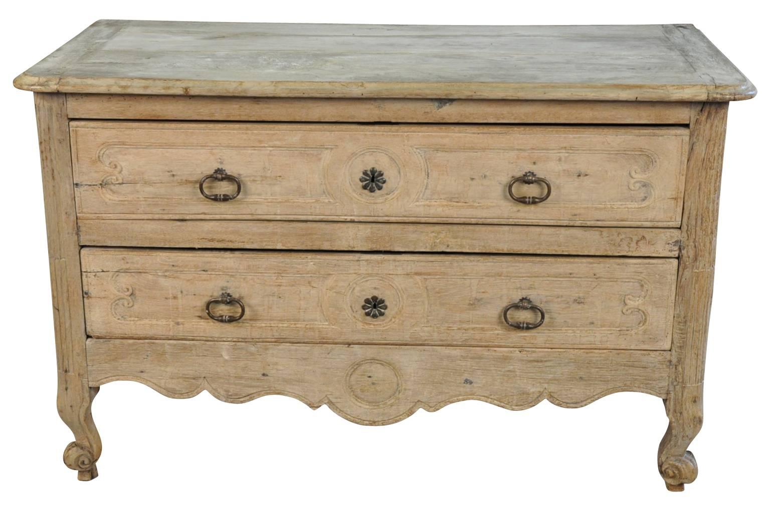 A stunning 18th century commode from the Provence region of France. Soundly constructed from washed or bleached oak with two drawers and wonderfully sculpted aprons. A wonderful chest for any living area, bedside or as a bathroom vanity.