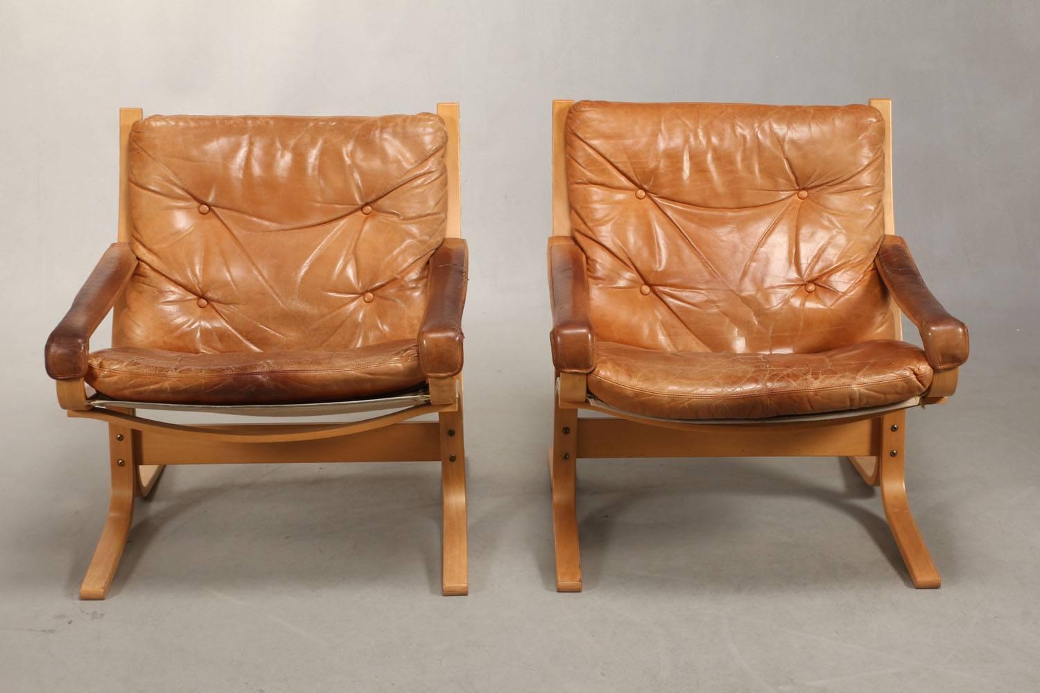 Pair of Leather Siesta lounge chairs designed by Ingmar Relling for Norwegian West Nova. Nice heavily patient leather. Light bended wood and nice patinaed leather cushions and arm straps. Also available in grey, please call for information.