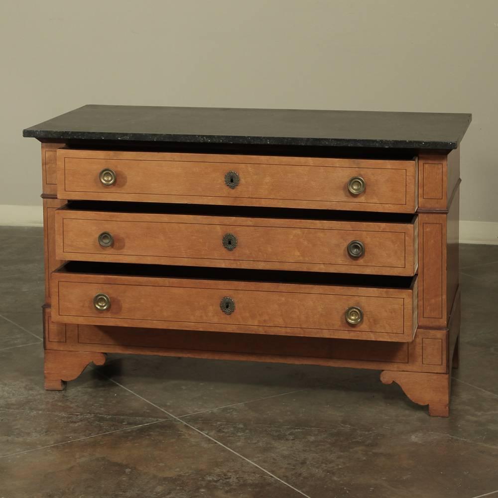 This handsome Antique French Charles X Period Commode was hand-crafted from finely figured bird's-eye maple then given heart walnut inlay simple lines bordering, boasting its original grey/black fossil marble top and original engraved brass pulls