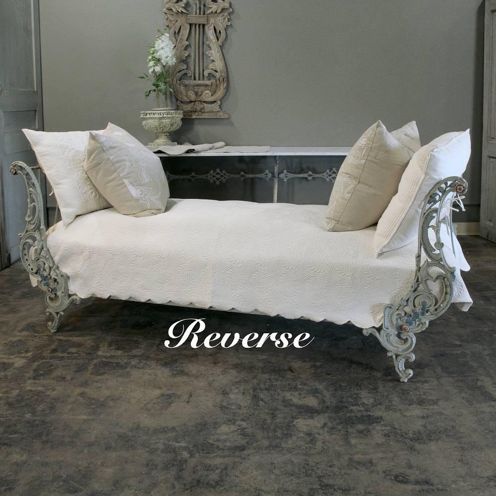 Designed to collapse into a compact package for ease in transport, this amazingly well-preserved 19th century French wrought iron Campaign Bed features a lovely pastel painted finish in two tones plus a delightful Baroque styling that will make this