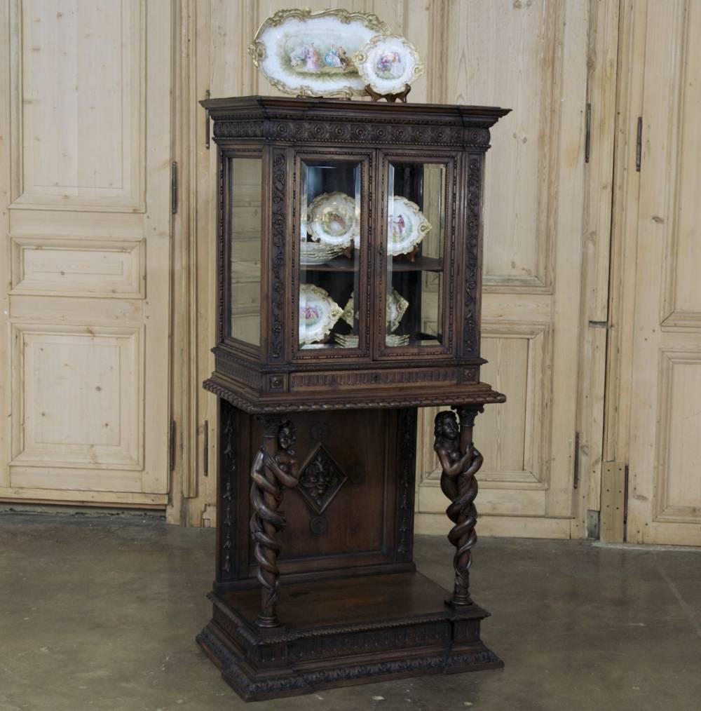 Stunning in its extraordinary detail, this 19th century Italian Renaissance Revival walnut vitrine has been hand-carved entirely from sumptuous walnut from the crown to the base, with a combination of molding designs too numerous to mention here! Of