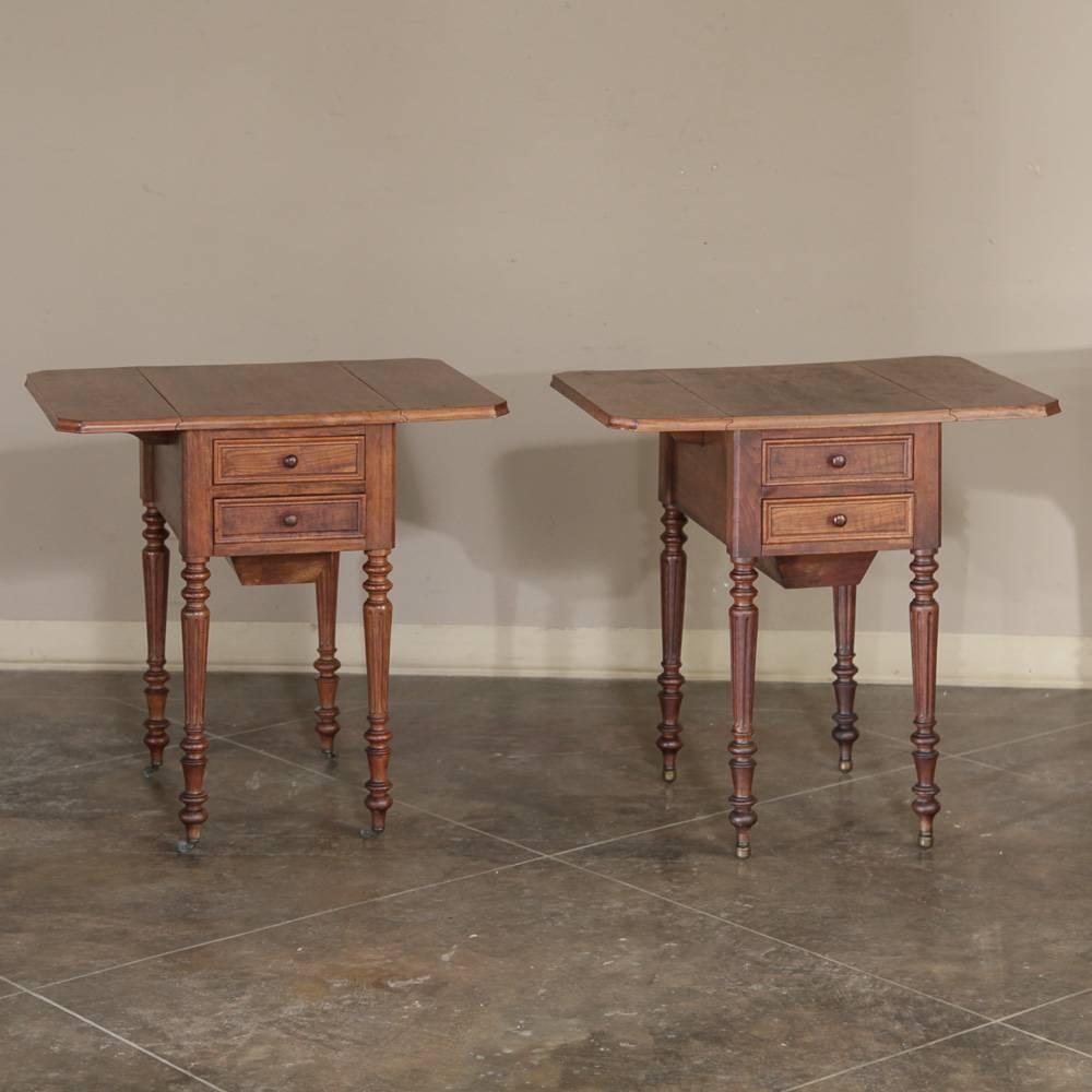 This expertly designed pair of French antique mahogany Louis Philippe nightstands or end tables will add versatility and interest to a bedroom or sitting area. An extended, somewhat concealed drawer below was originally a feature of sewing cabinets.