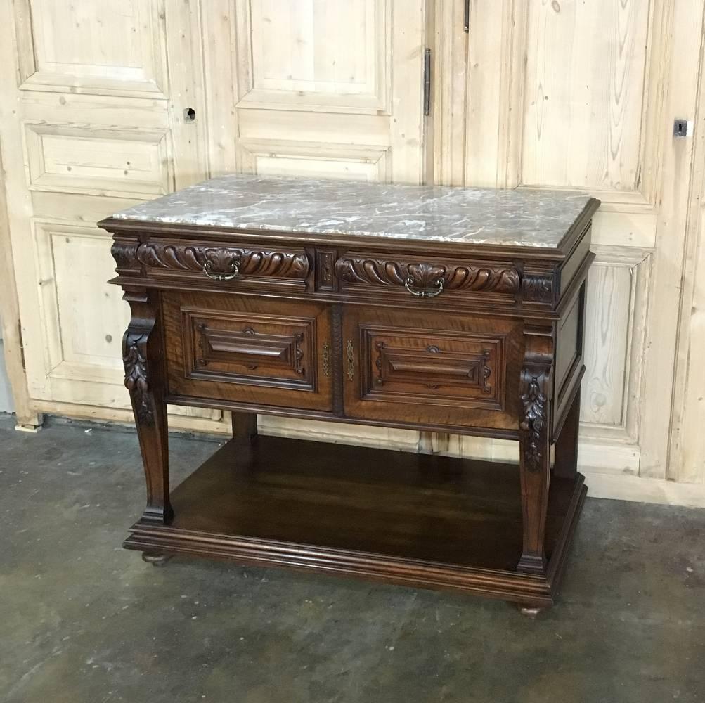This 19th century French Louis XIV walnut buffet is the perfect size for a niche or special place in the home or office, and features handcrafted excellence in cabinetry. The inset stone surface makes a carefree surface that is both elegant and