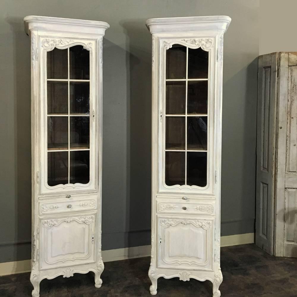 Yes, it's a pair of antique country French painted vitrines! Handcrafted and carved to perfection with scrolls, acanthus leaves and wildflowers, this mirror image pair are slender and tall, perfect for today's open floor plans! Asymmetrical arched