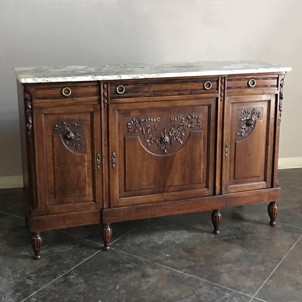Crafted exclusively from fine French walnut, cast bronze and luxurious marble, this 19th century French Louis XVI marble-top walnut buffet will add both elegance and functionality to any room,
circa 1890s.
Measures: 41.5 H x 63 W x 20 D.