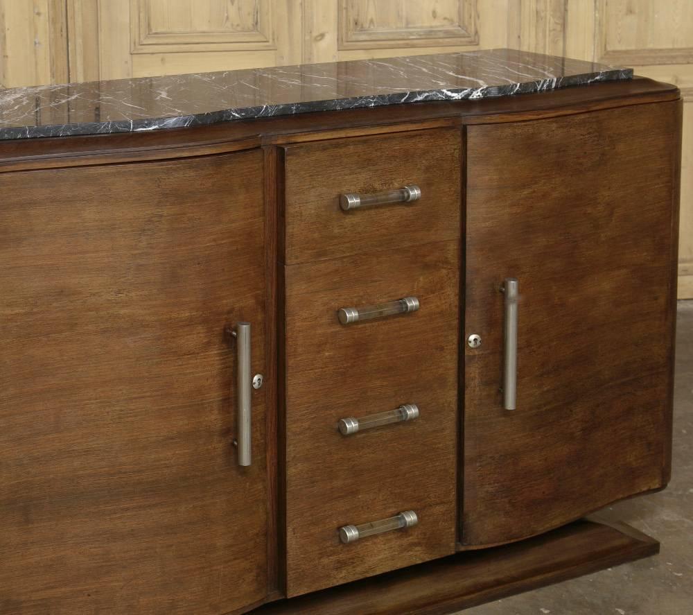 Featuring classic Art Deco lines and interior drawers, this French Art Deco period walnut buffet represents the essence of the style, and has been topped with elegant and carefree marble and original lucite, nickel  hardware.
circa 1930.
Measures: