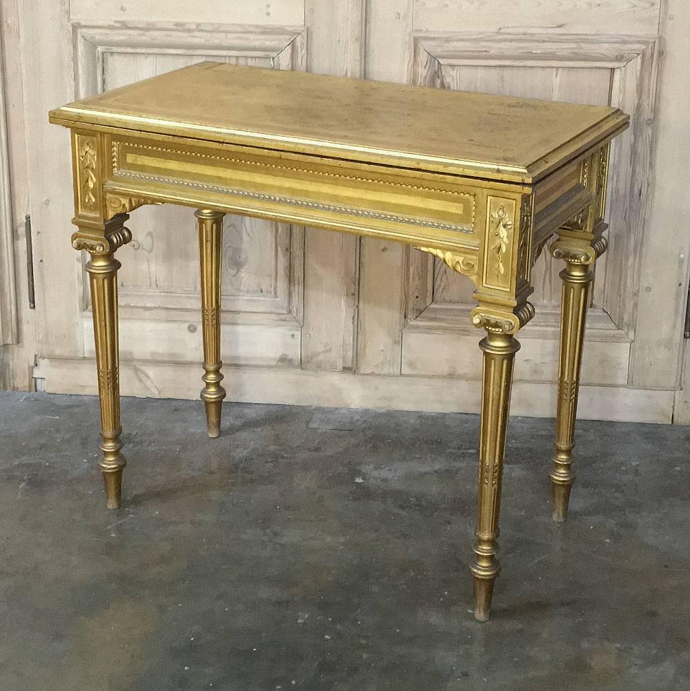 This remarkable 19th century French Louis XVI giltwood console or game table was handcrafted by master artisans in the neoclassical style that so enamored the court of King Louis XVI. Its ingenious design makes it look like an elegant console that