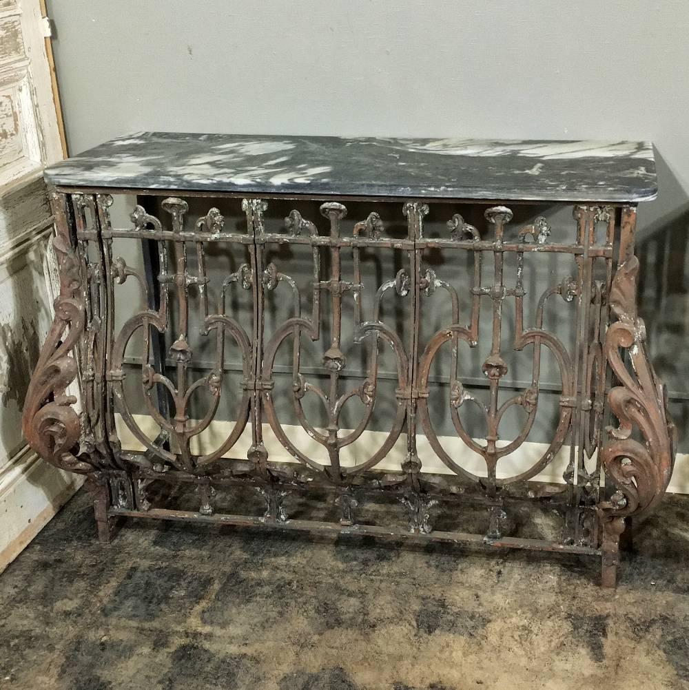 This remarkable pair of 19th century marble-top wrought iron French consoles are not only rare, but represent the epitome of the iron sculptor's art with elaborately scrolled bombe forms accentuated by bold yet elegantly formed acanthus plumes.