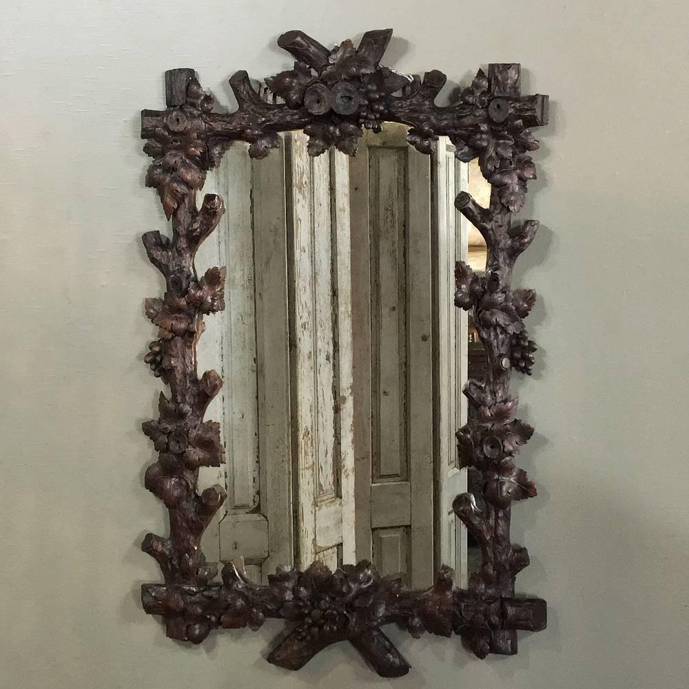 19th century Black Forest carved wood mirrors make perfect choices for bathrooms or areas where one needs a masculine touch! Hand-sculpted to perfection by talented artisans, each is a work of art unto itself. This particular example evokes an