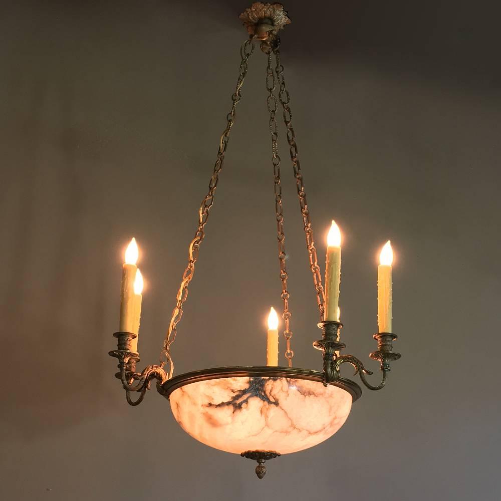 This elegant antique French Louis XVI neoclassical bronze and alabaster chandelier features the combination of polished stone with intricately cast bronze to create the perfect ambiance for any room! Classic styling of which Louis XVI was so fond is