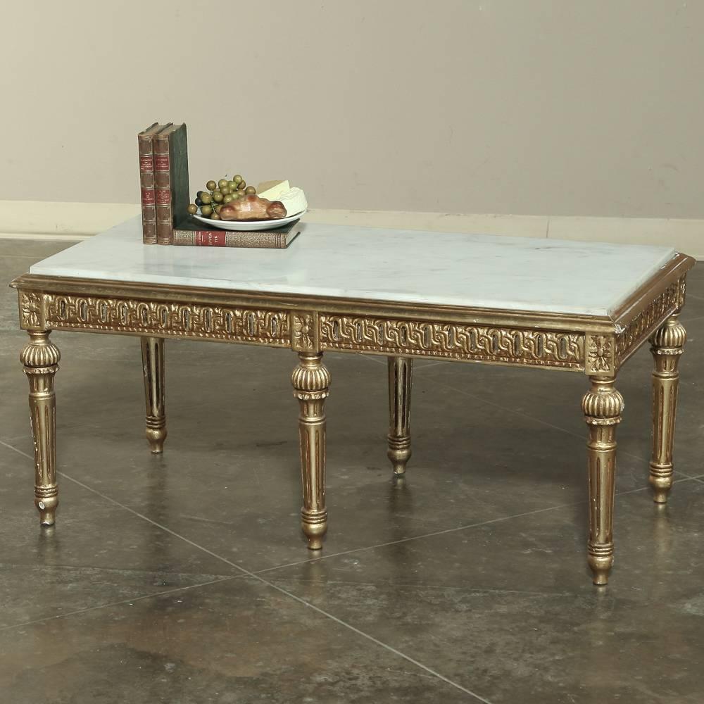 It can be said that no one does neoclassical like the Italians, and here's proof. This gorgeous Italian giltwood coffee table has been styled with motifs that date back 3,000 years, highlighted by the opulence of the gold finish. Topped with Carrara