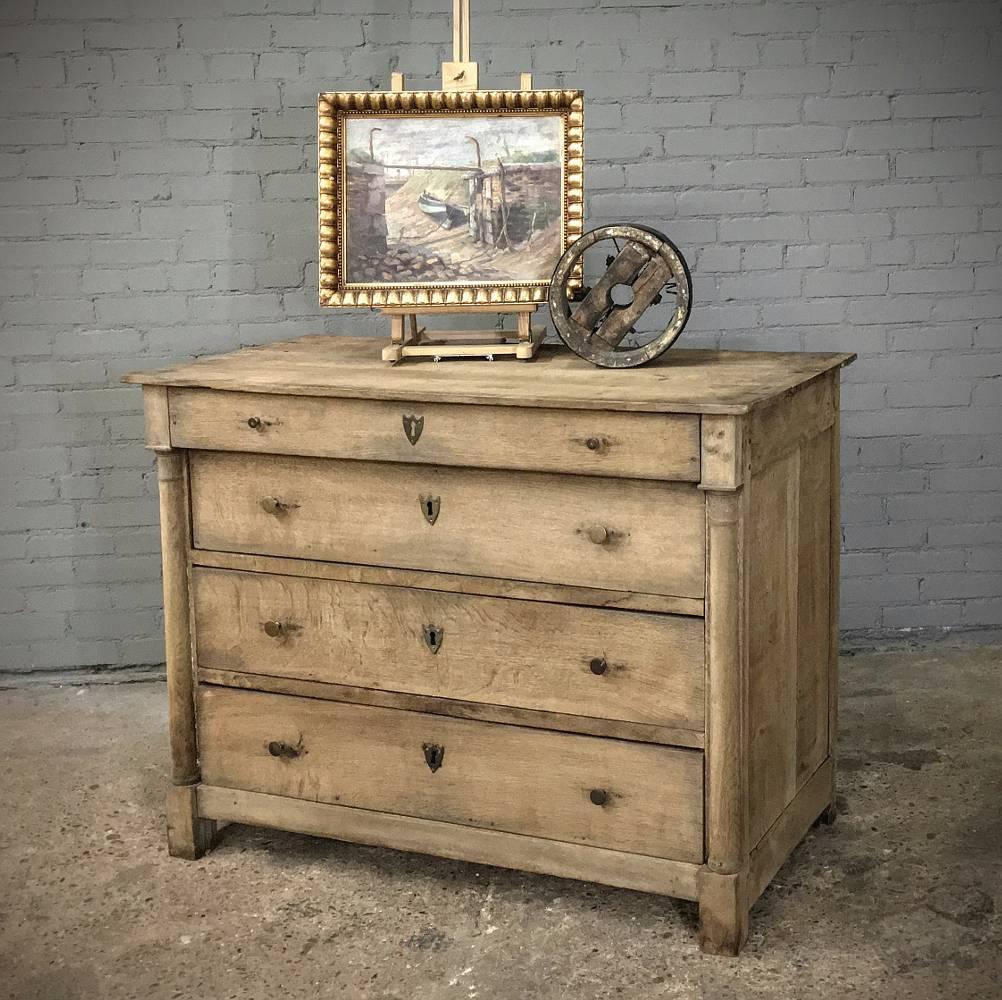 Rustic 19th century Country French Empire stripped solid oak commode was bench made by able rural artisans in the style belatedly celebrated in the early years of the 1800s. When Napoleon's triumphant return from Elba fizzled, the styles moved on,