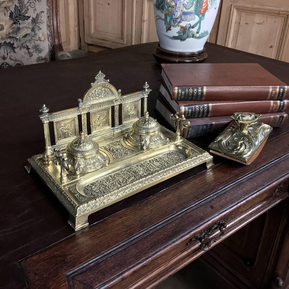 Cast from solid bronze, this elegant 19th century bronze neoclassical Inkwell includes a blotter and fitted porcelain ink inserts. Exquisite detail abounds in the casting consisting of three framed panels, a Stand for holding a pen, and a tray for