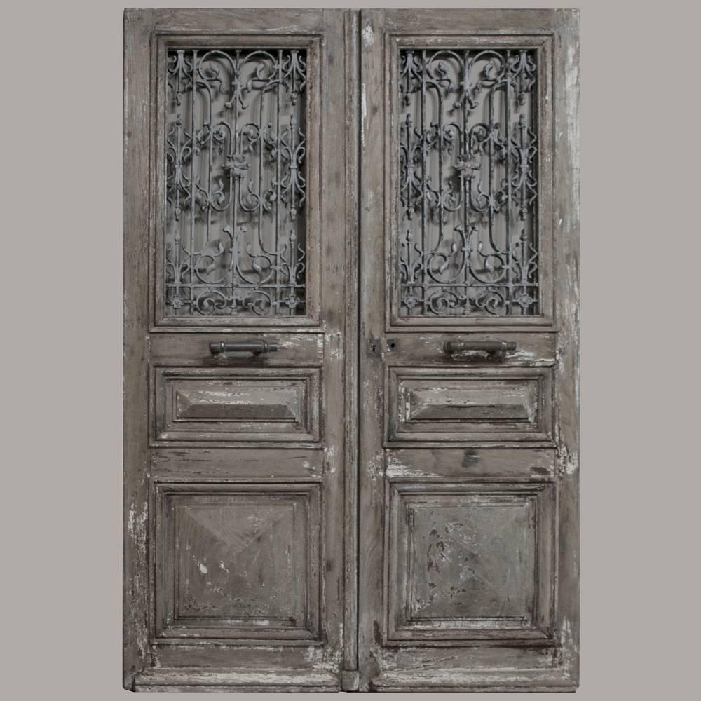 Salvaged from a beautiful chateau in Northern France, This pair of mid-19th century entry doors with wrought iron inserts survive with their original matching Traverse! Pegged mortise and tenon joinery in the solid oak construction ensures centuries