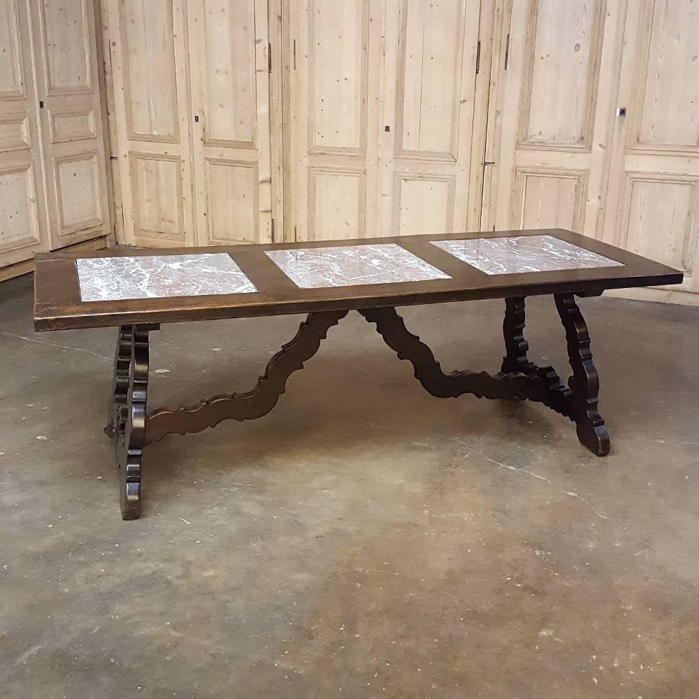 This unusual example of fine antique Spanish furniture craftsmanship in the form of an antique Spanish dining table features three rouge marble inserts on the top making it both unique and full of visual appeal! Pegged mortise & tenon joinery