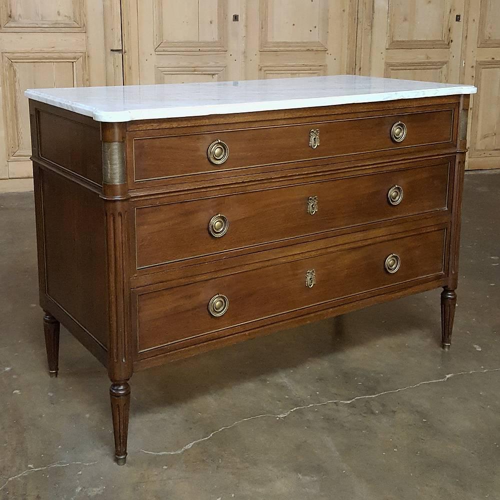 The understated elegance of this 19th century French Directoire marble-top commode make it the ideal choice for semi-formal to formal decors. Handcrafted from exotic imported mahogany, it features brass ornamentation on the fluted & rounded