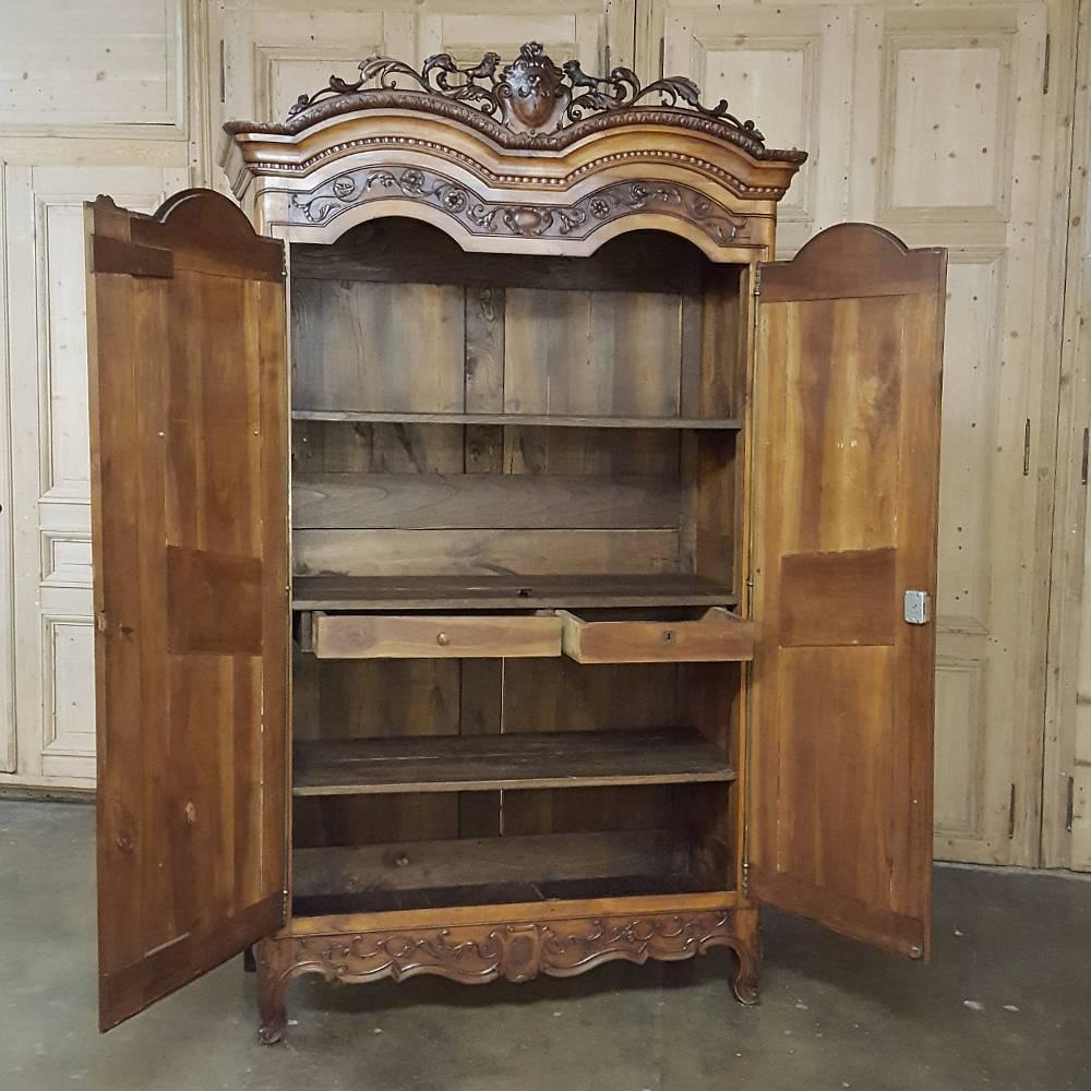 Completely handcrafted by the master artisans of Normandie, this stunning 18th century country French Normandie armoire was created from local apple wood, giving it a color that is unparalleled in the world of timeless furniture! Elaborate foliate