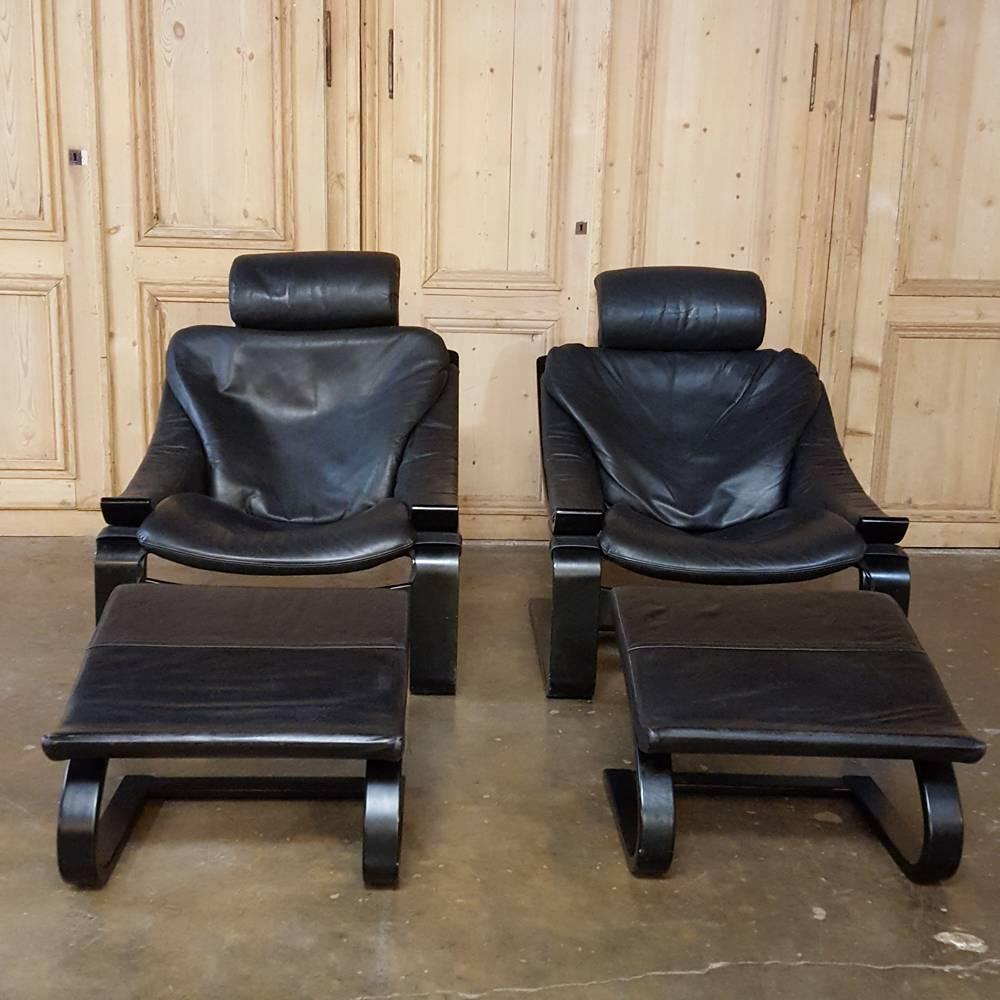 Exceptionally rare to survive with their original footstools, this impressive pair of Nelo Swedish lounge chairs with matching ergonomic footrests feature their original supple leather upholstery which remains in exceptional condition! The chairs