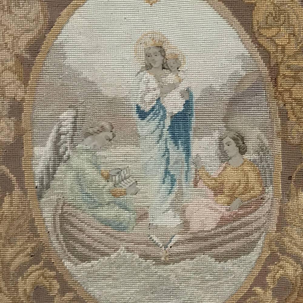 This stunning 19th century petite point giltwood framed tapestry depicts the Virgin Mary holding an infant Jesus in a boat crewed by angels in a remarkable feat of artistic weaving including needlepoint around the main petite point work at the