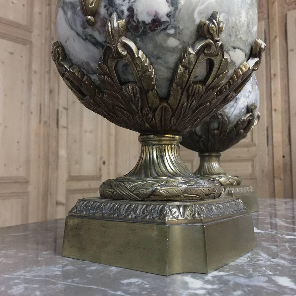 Pair of 19th century Belle Époque marble and bronze mantel urns represent the epitome of Classic decor! handcrafted from solid marble and bronze mounts that were hand-cast in the form of swans, floral sprays, ribbon and lotus rosettes. The