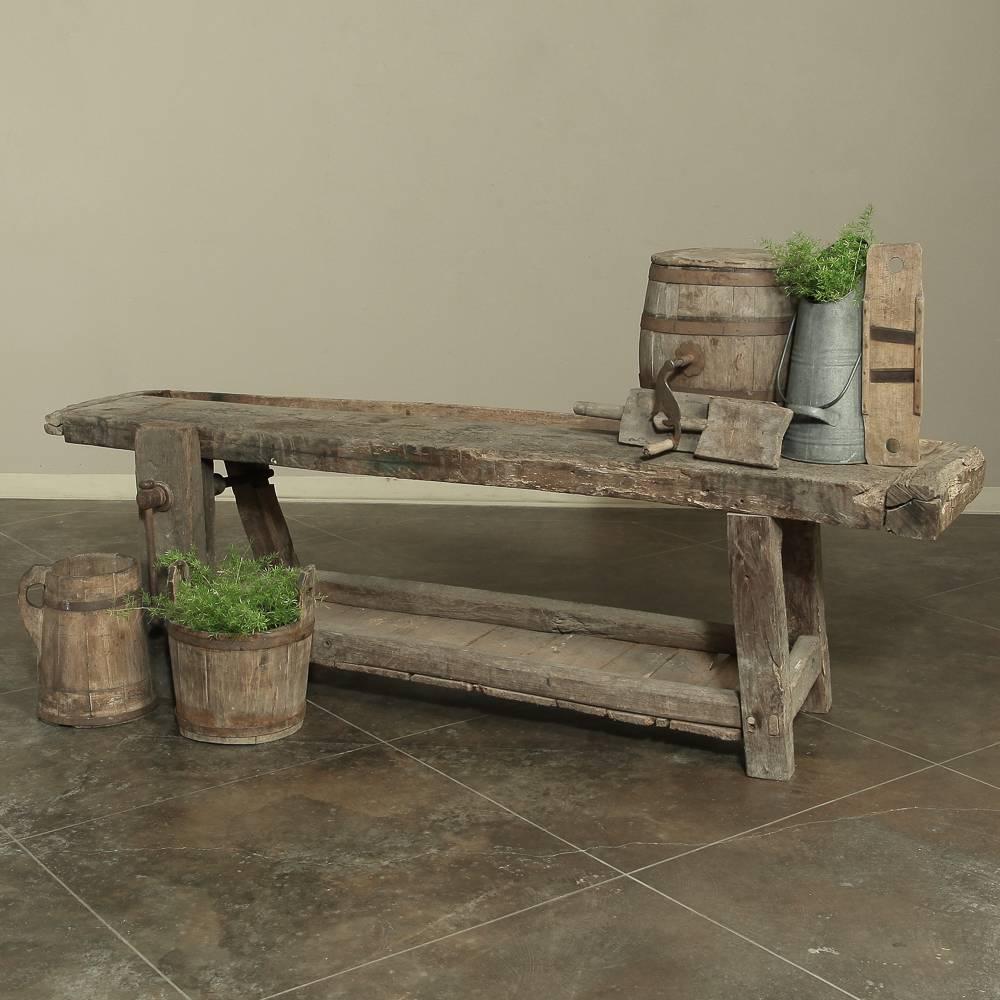 Perfect for the rustic decor, this Antique French carpenter's Workbench is equipped with original and still functional wood and iron vice! The recessed tray used for holding a craftsman's tools and implements will come in just as handy in a modern