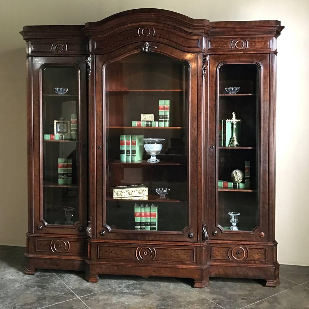 Only rarely do we discover true Louis Philippe Period pieces in such good condition, and especially on such a grand scale as this magnificent 19th century, French, Louis Philippe mahogany bookcase! Rendered entirely from the exotic imported mahogany