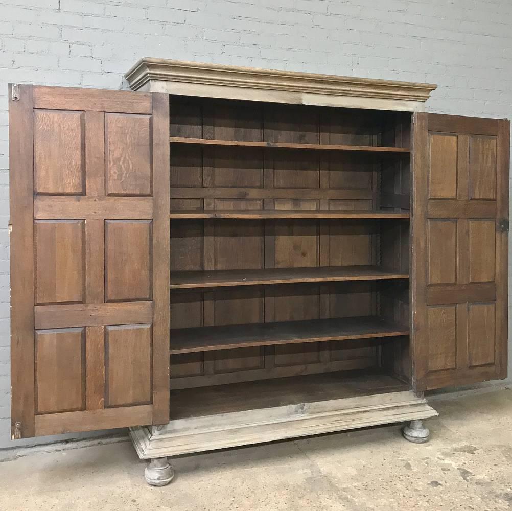 This 19th century Renaissance stripped oak armoire is a remarkable study of a family's particular ancestry, going back multiple generations, with likenesses all sculpted in glorious full relief from solid old-growth oak to memorialize them for