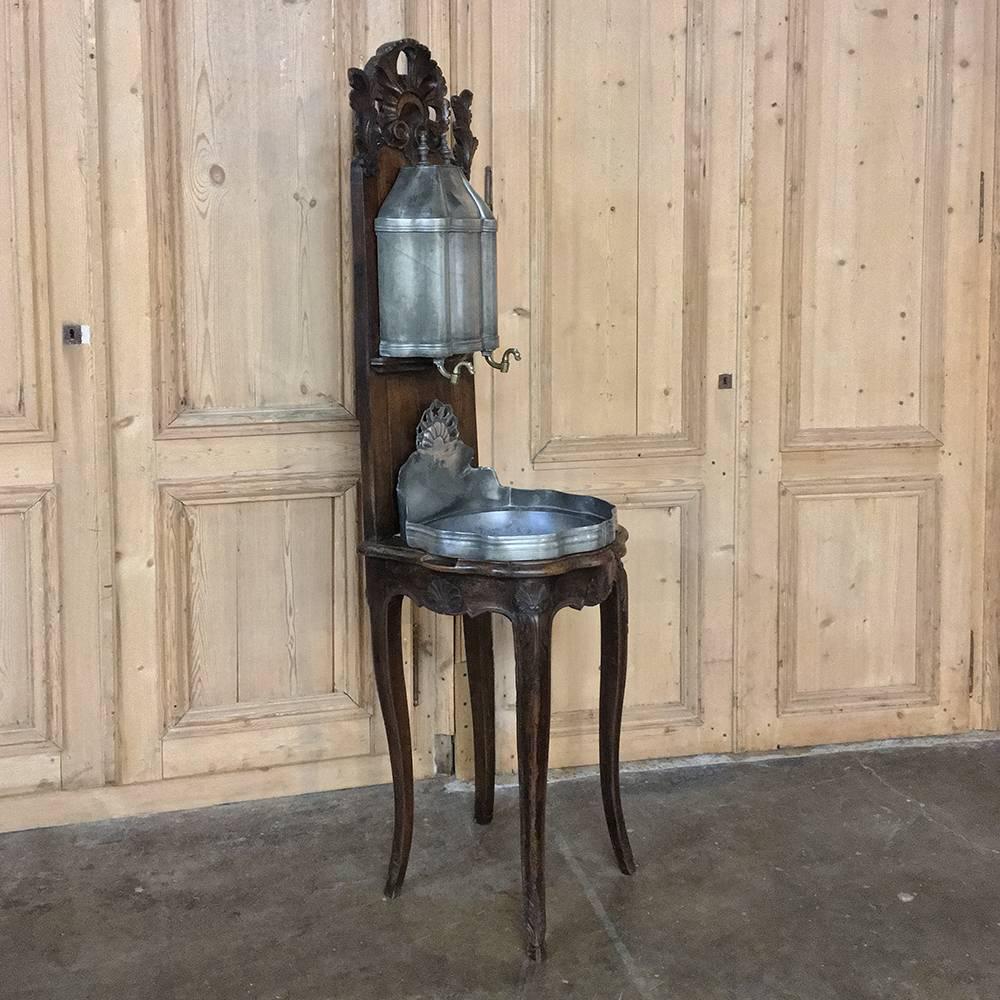18th Century Pewter wall fountain with cherrywood stand is a reminder of a bygone era during the days before hot and cold running water in most rooms of the home! Such fountains would be placed next to the rear entrance of a farm home, so that when