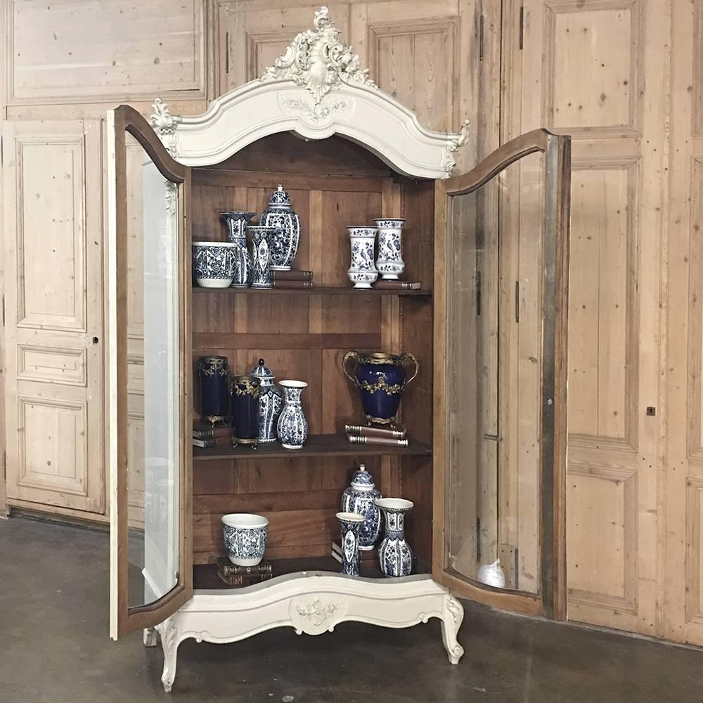 This stunning 19th century French Louis XV painted display armoire ~ bookcase is the perfect choice to display one's most cherished collection, family memorabilia, sports trophies, you name it! Handcrafted by master artisans from fine French walnut,