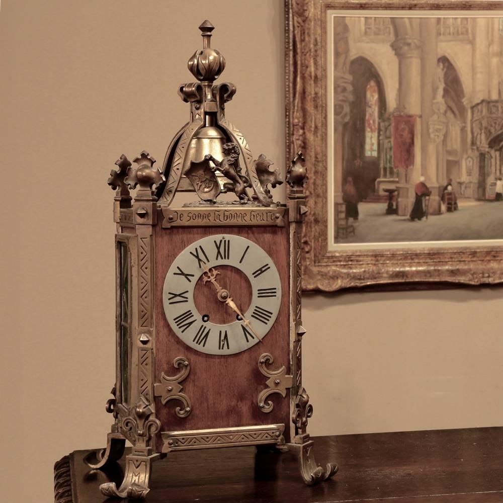 Antique Gothic Revival bronze and wood mantel clock is a charming way to add an Old World touch to any room! Engraved onto the plaque above the dial face in French is the phrase 