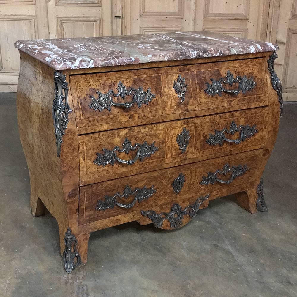 19th century French marble-top marquetry bombe commode is the result of four talented artisans to create a visually stunning end product that is unusually shallow for this type! First, the cabinetmaker carefully hand-crafts the casework with its