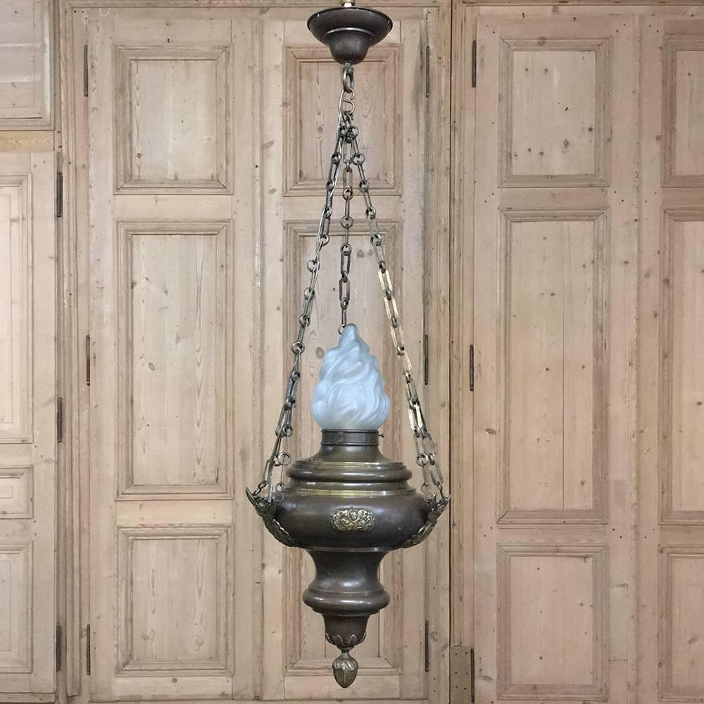 19th century oil lantern French chandelier - originally from a French chapel features magnificent cast bronze mounts which depict cherubs in a triumvirate, with an angel in full flight as well! A pendant finial below the urn shape adds a nice touch,
