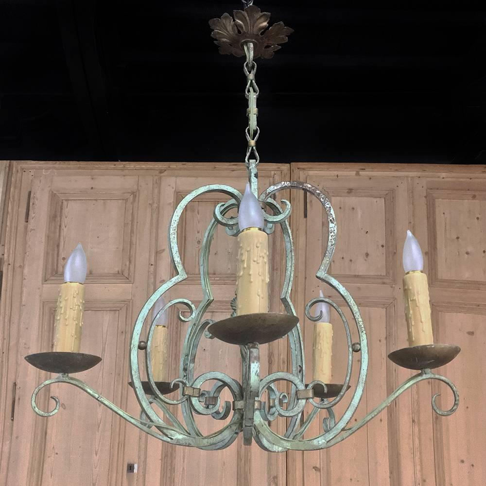 Antique Country French painted hand forged wrought iron chandelier is a wonderful expression of the metalsmith's art! Graceful scrollwork abounds on the entire fixture, with spiral center finial that steals the show! Painted finish has achieved a