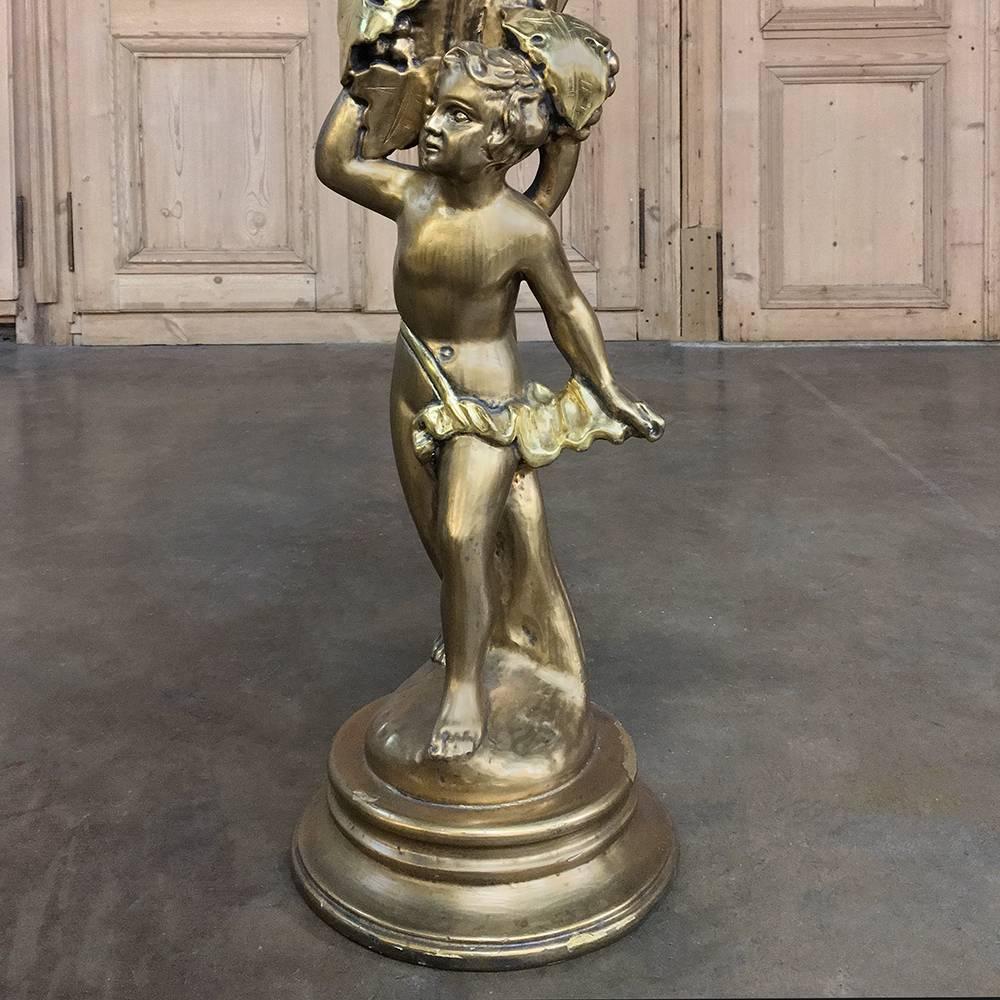 This stunning antique Italian giltwood Baroque pedestal remains in exceptional condition, and was hand-sculpted from solid wood to depict a cherub amongst fully laden grapevines before being given a luxurious gold finish. Perfect for displaying a