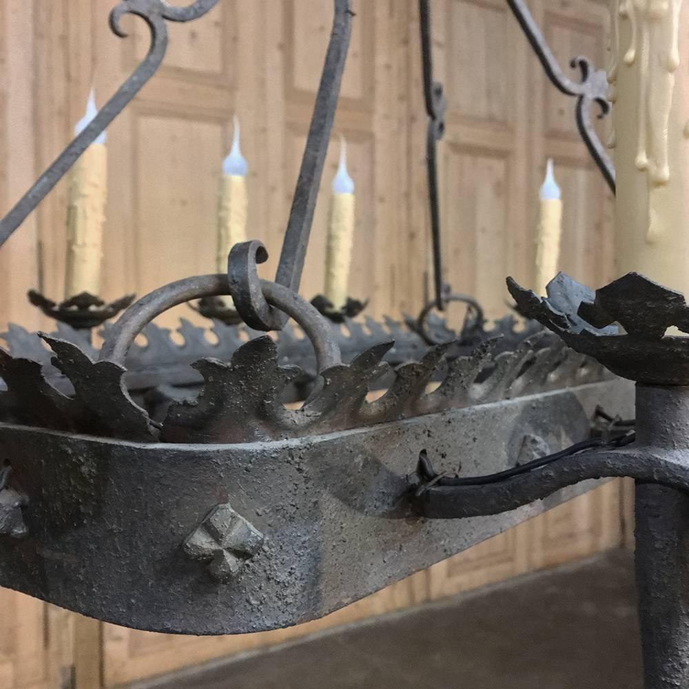 Antique wrought iron chandelier is perfect for the casual decor, a Country French look, or anywhere one appreciates Fine craftsmanship! The rectangular shape allows ten chandelles mounted on torcheres around the perimeter, which has been adorned